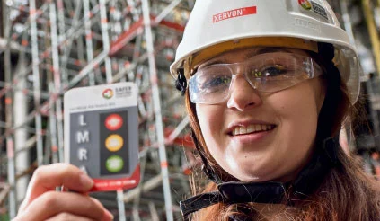 An employee holding an LMRA card up to the camera